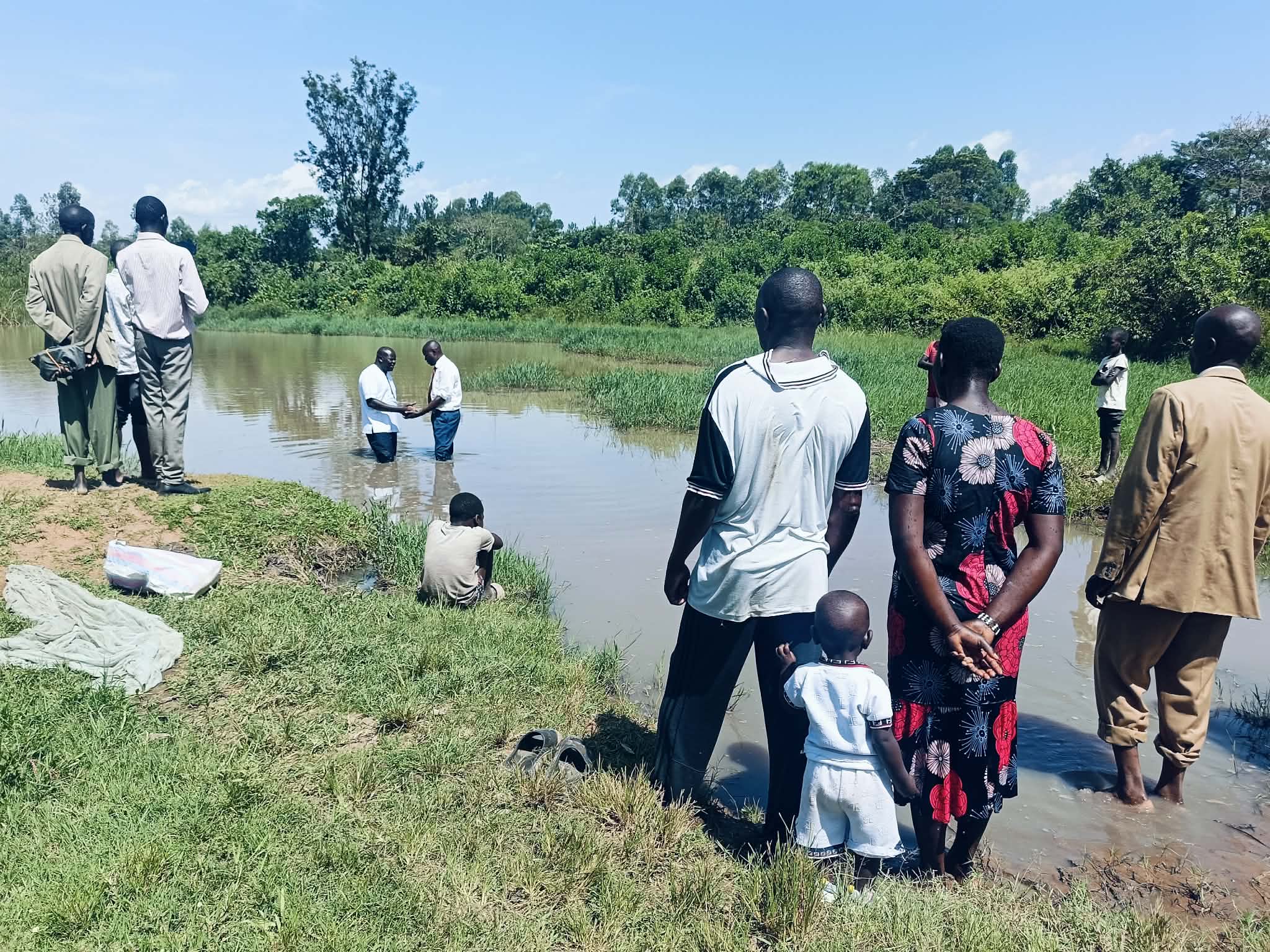 Believers gathered by the water for a baptism in Kenya